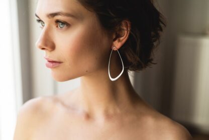 Silver sustainable ethical conscious bridal ebb tide earrings on model